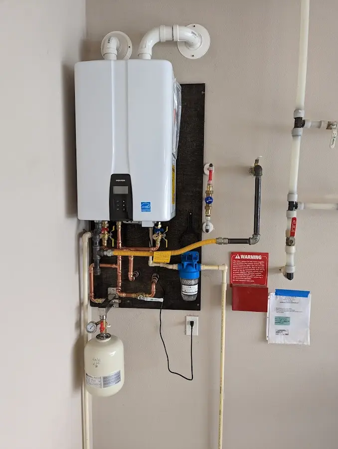 Professional plumber installing copper piping in a Windsor home